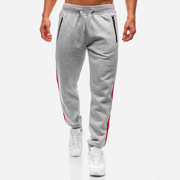 Herren nan schmal zulaufende Fleece-Jogginghose mit zweifarbiger Seitenpaspel und wasserabweisenden Reißverschlusstaschen Drune