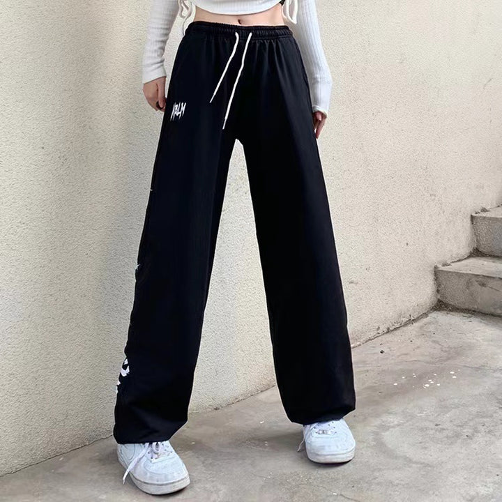 Damen nan locker geschnittene Wide‑Leg Jogginghose mit hohem Bund und markantem Seitenschriftzug Drune