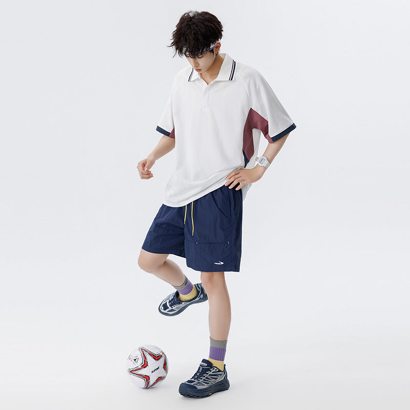 Unisex Boxy Oversize Polo-Shirt aus technischem Funktionsjersey mit Kontrastpaneelen und Raglanärmeln Drune