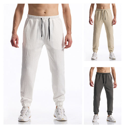 Herren Jogginghose mit elastischem Bund, Tunnelzug und geprägtem Allover‑Logo‑Relief Drune