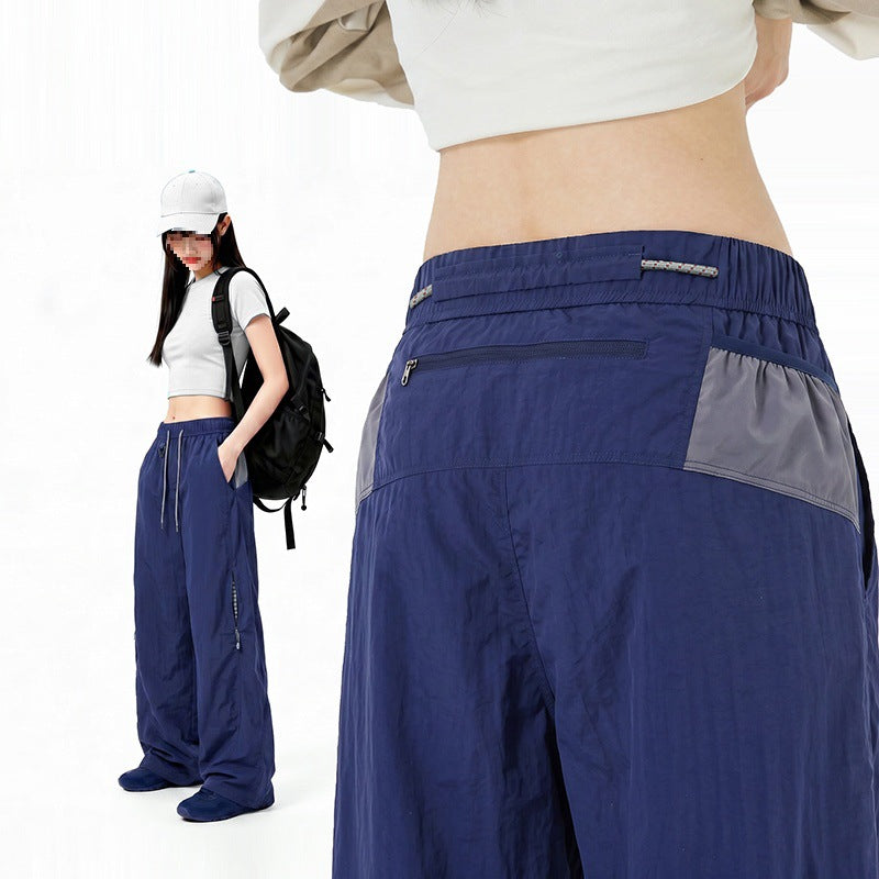 Damen Oversize Tech-Loungehose mit Kontrastnähten, reflektierenden Reißverschlusstaschen & Kordelbund Drune
