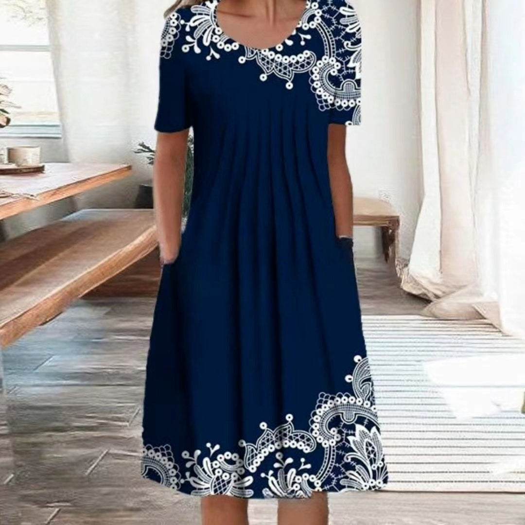 Damen Plissee Midi Kleid mit kurzen Ärmeln, seitlichen Taschen und floralem Saum Drune
