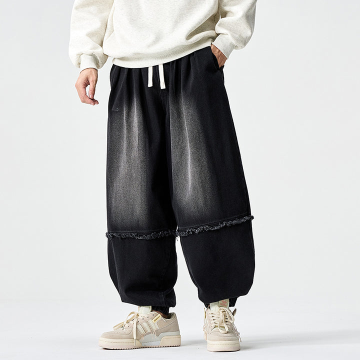 Herren Weit geschnittene Baggy-Denim-Hose mit Tunnelzug, elastischen Beinabschlüssen und Fransen-Detail Drune