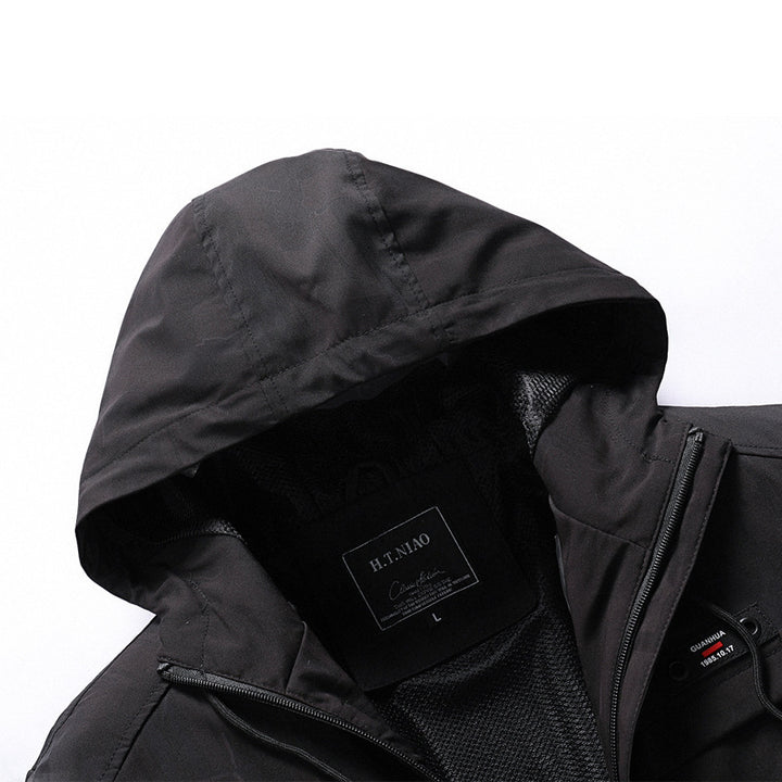 Herren Leichte Softshell‑Hybridjacke mit Netzfutter, wasserabweisender Membran und Reißverschlusstaschen Drune