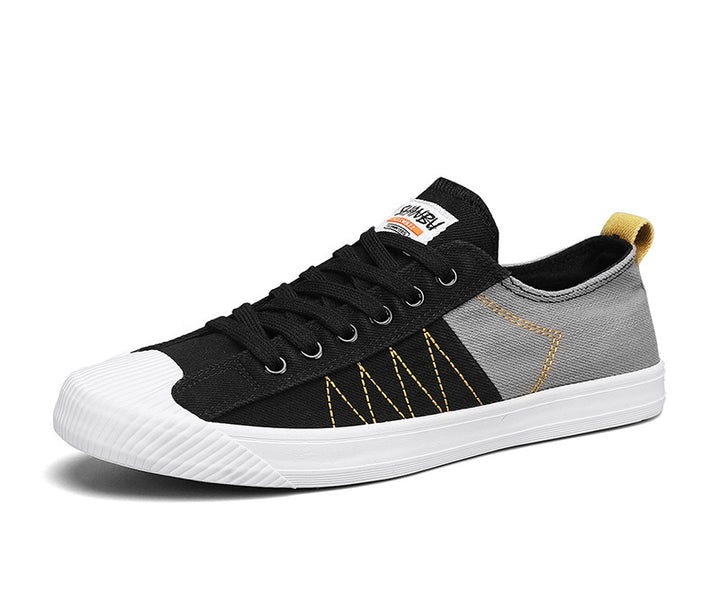 Unisex niedrige Canvas-Sneaker mit verstärkter Gummi-Zehenkappe und kontrastierenden Textilpaneelen Drune
