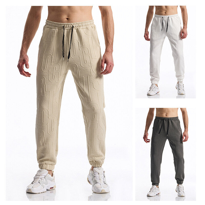 Herren Jogginghose mit elastischem Bund, Tunnelzug und geprägtem Allover‑Logo‑Relief Drune