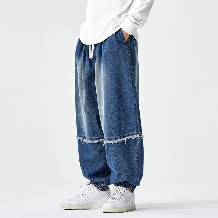 Herren Weit geschnittene Baggy-Denim-Hose mit Tunnelzug, elastischen Beinabschlüssen und Fransen-Detail Drune
