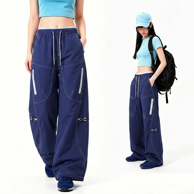 Damen Oversize Tech-Loungehose mit Kontrastnähten, reflektierenden Reißverschlusstaschen & Kordelbund Drune
