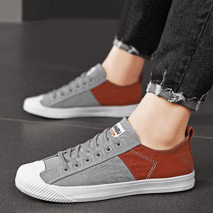 Unisex niedrige Canvas-Sneaker mit verstärkter Gummi-Zehenkappe und kontrastierenden Textilpaneelen Drune