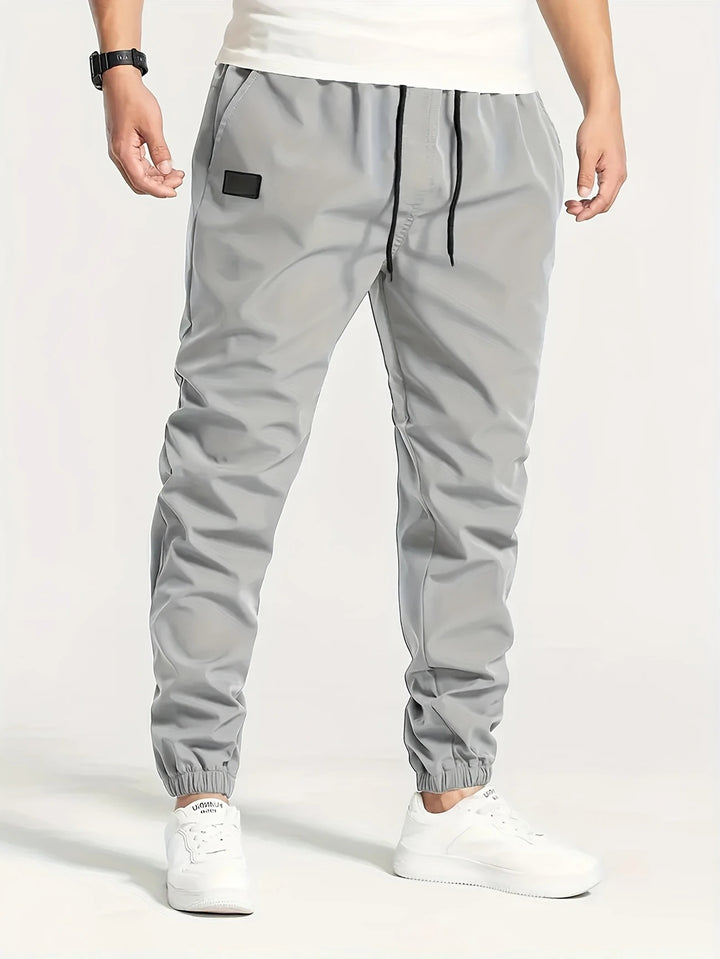 Herren Technische Jogginghose im Tapered‑Utility‑Stil mit elastischem Bund & Knöchelbündchen Drune