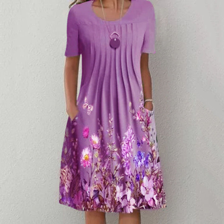 Damen Plissee Midi Kleid mit kurzen Ärmeln, seitlichen Taschen und floralem Saum Drune
