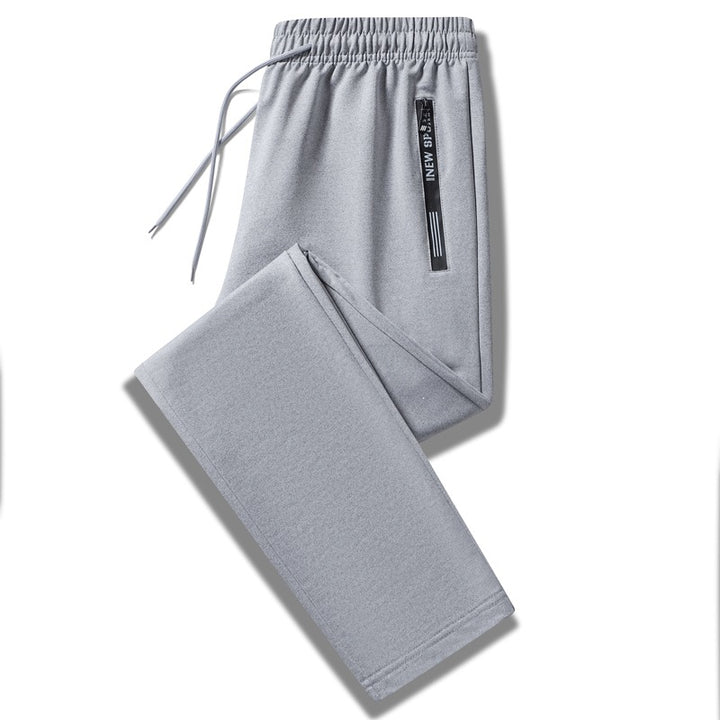 Herren Sportliche Trainingshose mit elastischem Tunnelzugbund, Reißverschlusstasche und glattem Performance‑Material Drune
