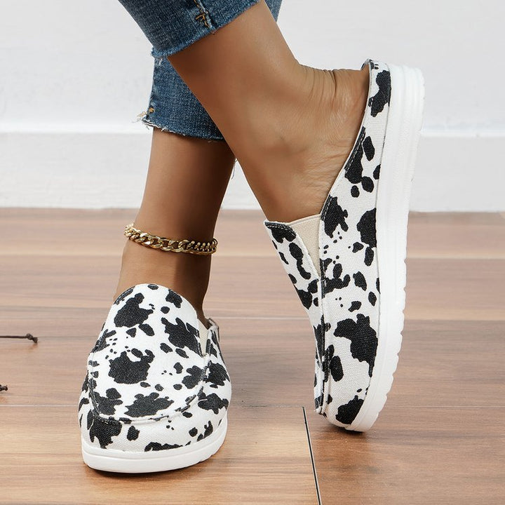 Damen  Slip-On Canvas‑Mules mit Kuhfleckenprint, gepolstertem Komfortfußbett und rutschfester Leichtsohle Drune