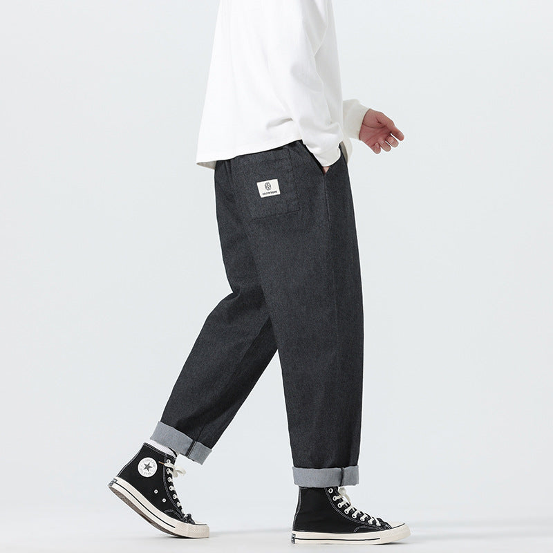 Herren Locker geschnittene Cropped-Denimhose mit Umschlag und Label-Patch Drune