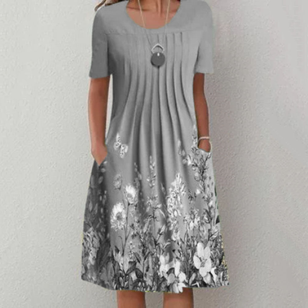 Damen Plissee Midi Kleid mit kurzen Ärmeln, seitlichen Taschen und floralem Saum Drune