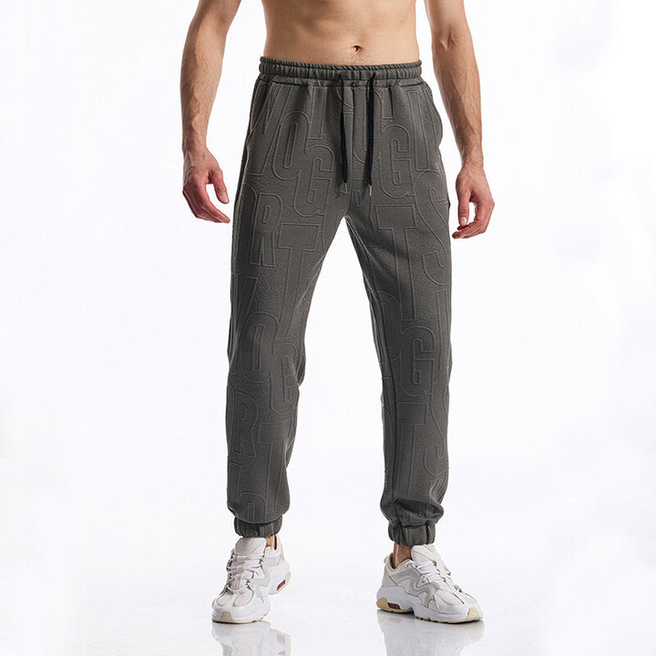Herren Jogginghose mit elastischem Bund, Tunnelzug und geprägtem Allover‑Logo‑Relief Drune