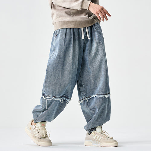 Herren Weit geschnittene Baggy-Denim-Hose mit Tunnelzug, elastischen Beinabschlüssen und Fransen-Detail Drune