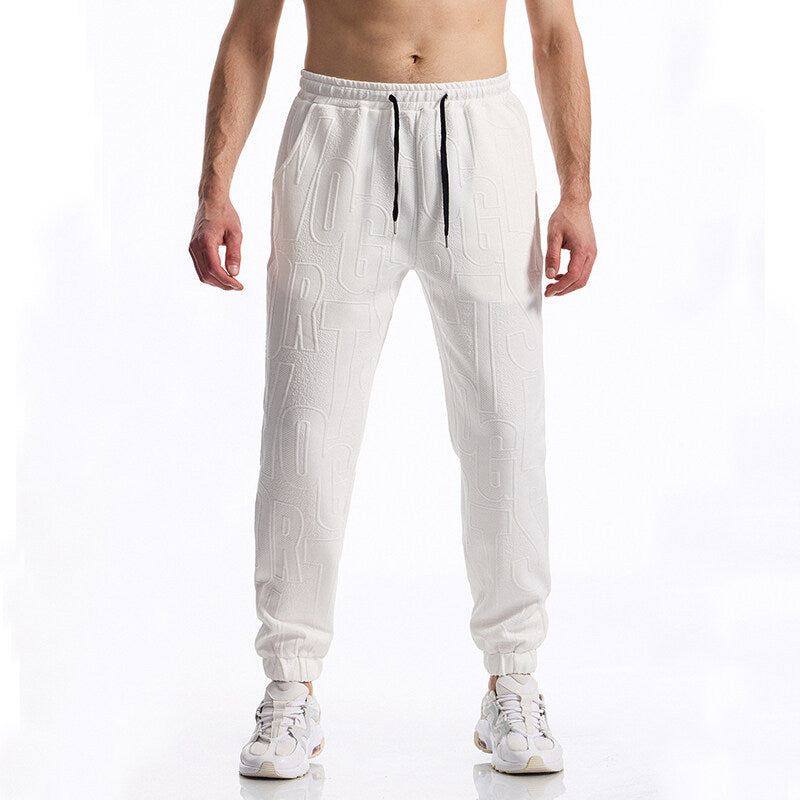 Herren Jogginghose mit elastischem Bund, Tunnelzug und geprägtem Allover‑Logo‑Relief Drune