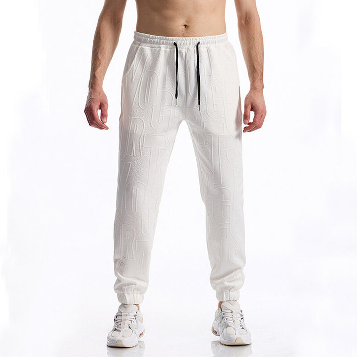 Herren Jogginghose mit elastischem Bund, Tunnelzug und geprägtem Allover‑Logo‑Relief Drune