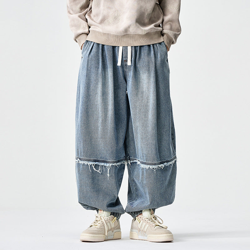 Herren Weit geschnittene Baggy-Denim-Hose mit Tunnelzug, elastischen Beinabschlüssen und Fransen-Detail Drune