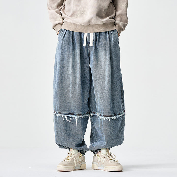 Herren Weit geschnittene Baggy-Denim-Hose mit Tunnelzug, elastischen Beinabschlüssen und Fransen-Detail Drune