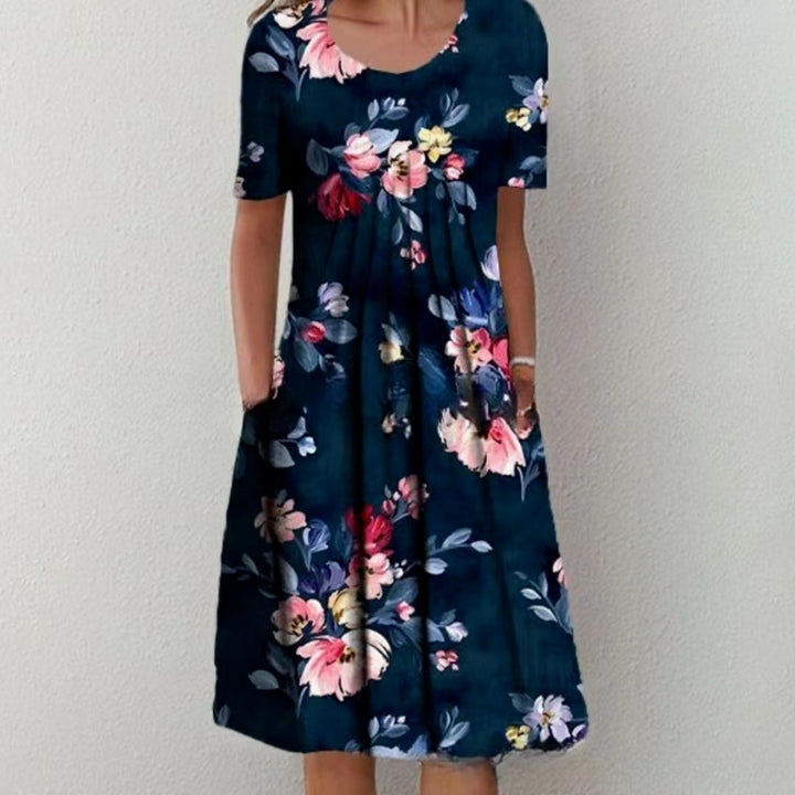 Damen Plissee Midi Kleid mit kurzen Ärmeln, seitlichen Taschen und floralem Saum Drune