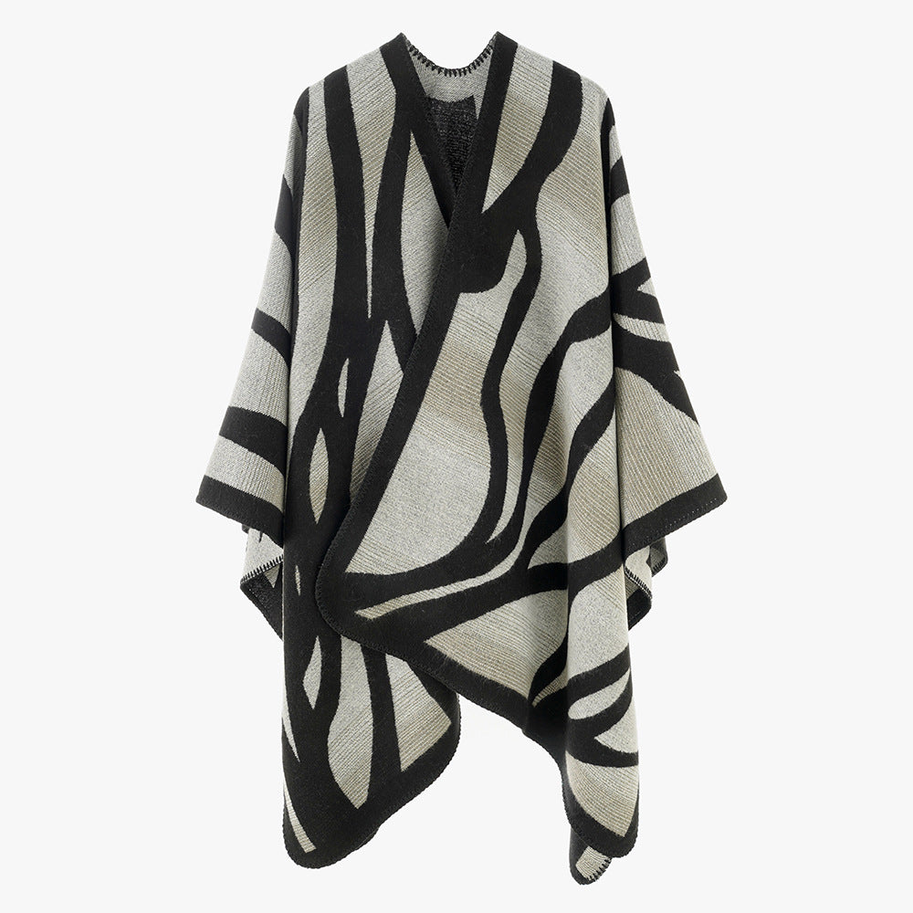 Damen Oversize-Strickcape mit abstrakter Wellenjacquard‑Struktur und kontrastierter Kettelkante Drune