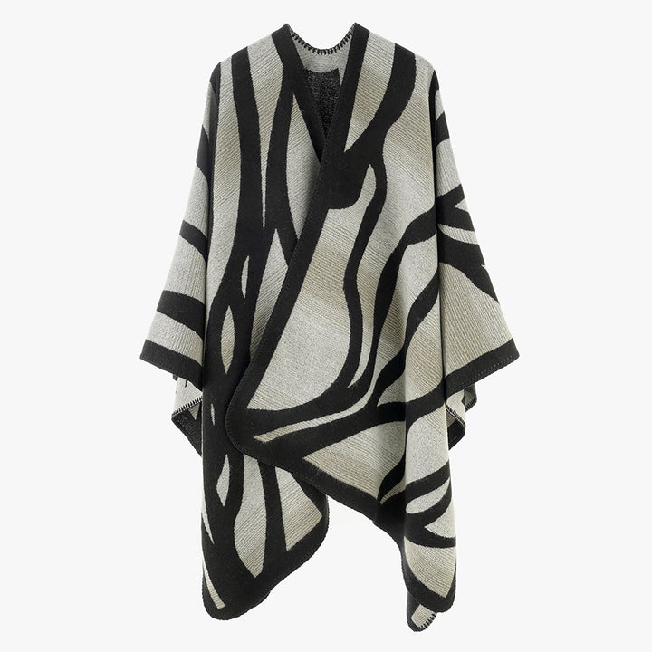 Damen Oversize-Strickcape mit abstrakter Wellenjacquard‑Struktur und kontrastierter Kettelkante Drune