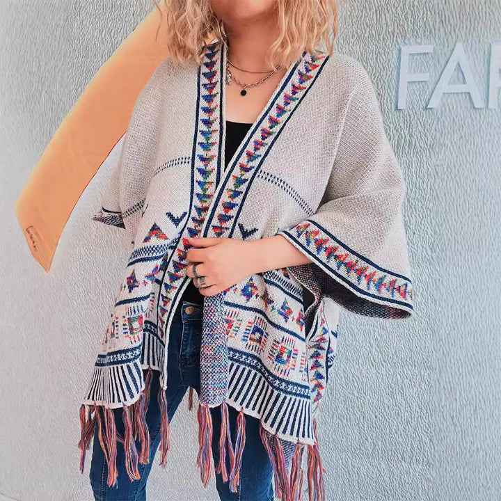 Damen modische Strickponcho mit fransenverzierter Kante und buntem Muster Drune