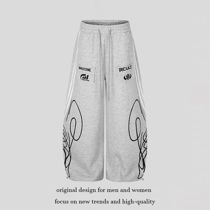 Damen Weite Midilounge‑Sweathose im Palazzo‑Cut mit Tunnelzug, Zip‑Saum und Statement‑Print Drune