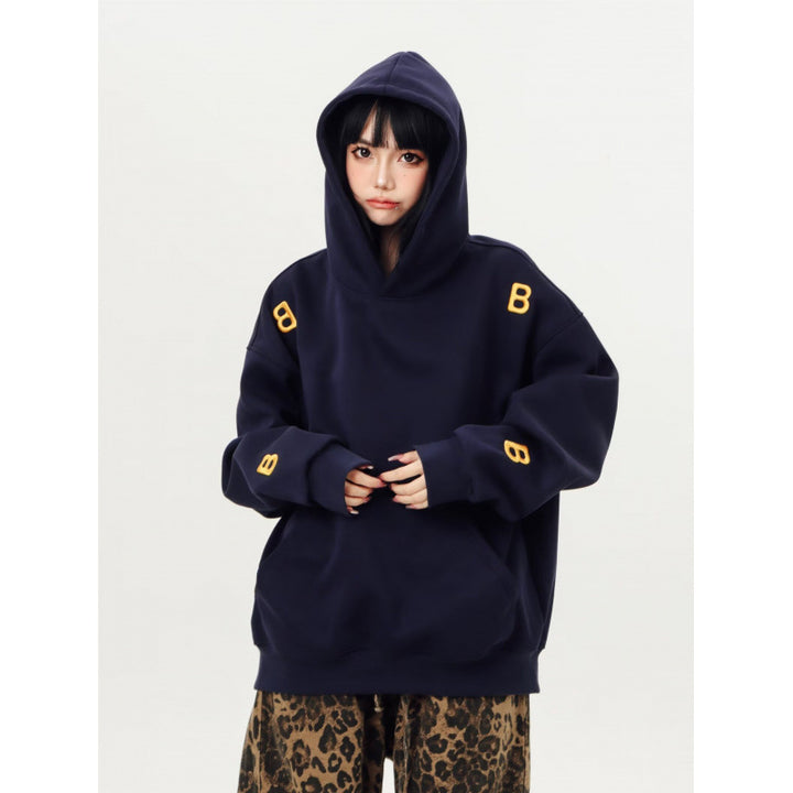 Unisex Oversized Kapuzenpullover mit großflächigem Intarsien‑Blockprint und geripptem Saum Drune