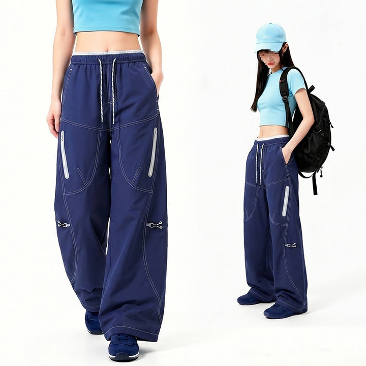 Damen Oversize Tech-Loungehose mit Kontrastnähten, reflektierenden Reißverschlusstaschen & Kordelbund Drune