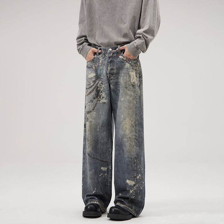 Herren Weit geschnittene Stonewashed-Denim-Jeans mit Kettenprint, Farb‑Splatter und bodenlangem Saum Drune