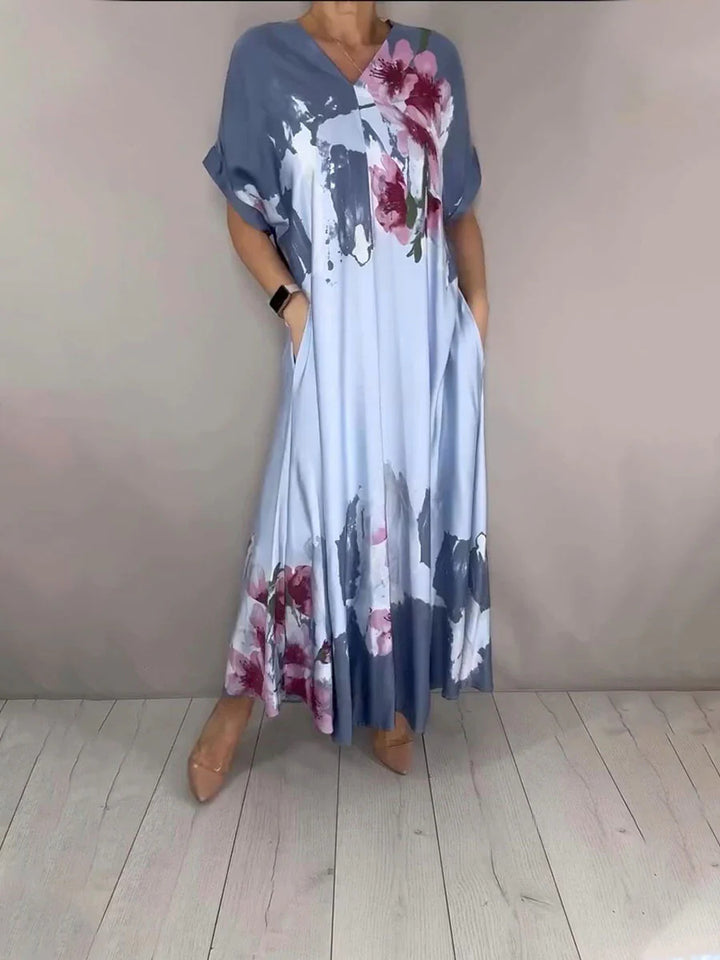 Damen Maxikleid mit weitem Fall, V-Ausschnitt, Eingrifftaschen und floraler Aquarelloptik Drune