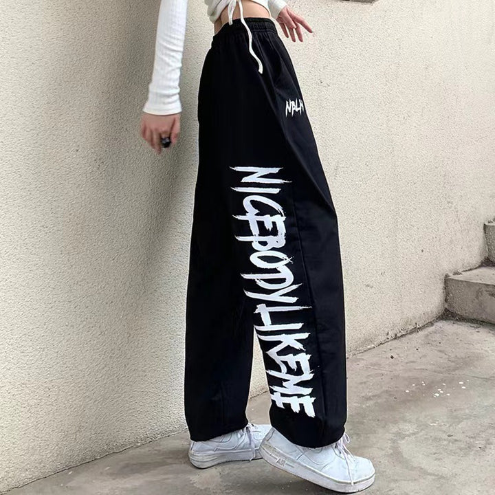 Damen nan locker geschnittene Wide‑Leg Jogginghose mit hohem Bund und markantem Seitenschriftzug Drune