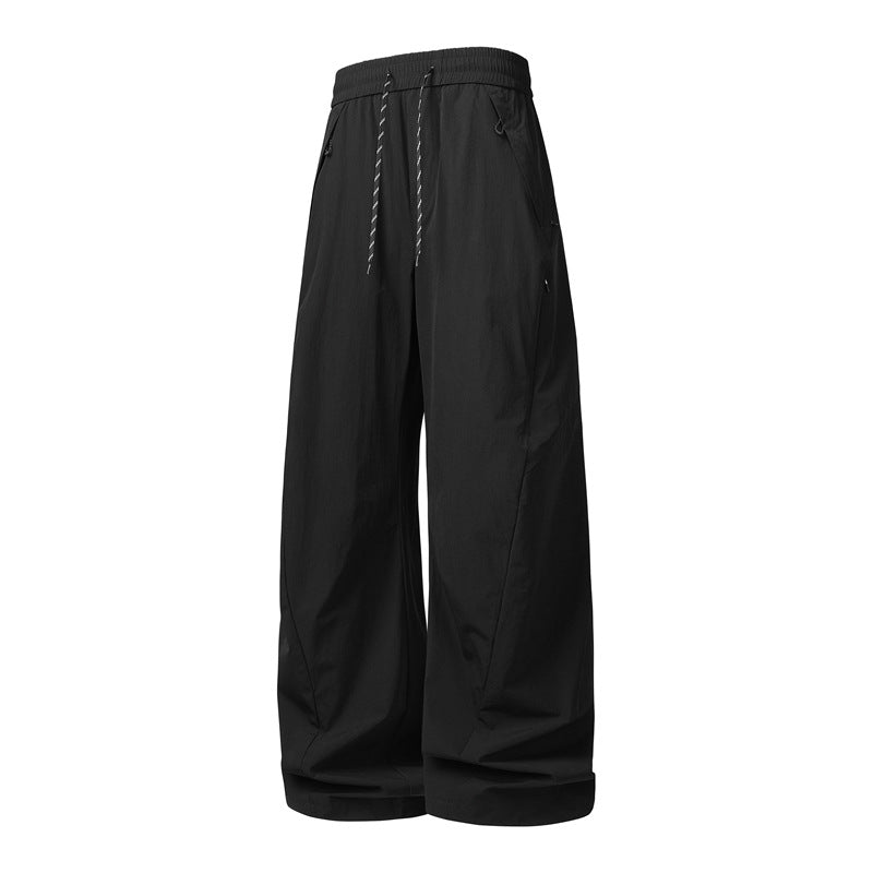 Unisex Weite Tech-Baggy-Hose mit elastischem Kordbund, Reißverschlusstaschen & wasserabweisender Nylonoptik Drune