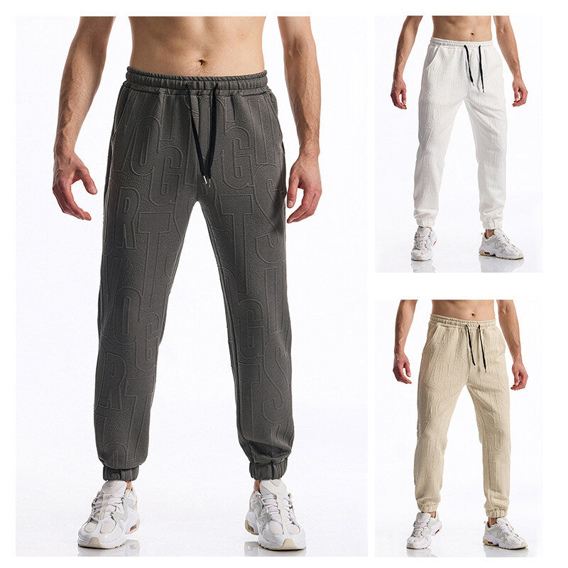 Herren Jogginghose mit elastischem Bund, Tunnelzug und geprägtem Allover‑Logo‑Relief Drune