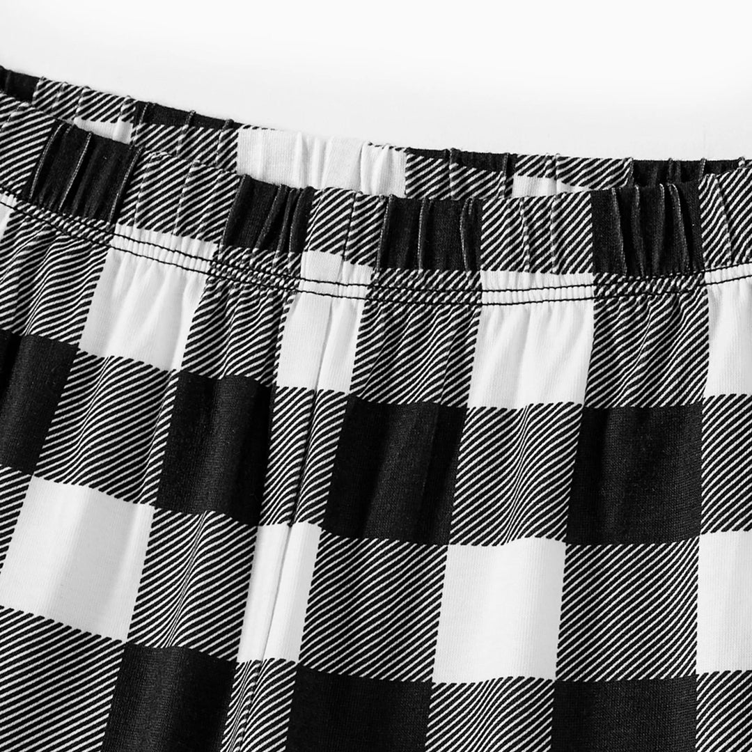 Drune | Paar Schwarz und Weiß Karierte Weihnachts-Pyjama-Set mit Weihnachtsmann und Cartoon-Muster Druck